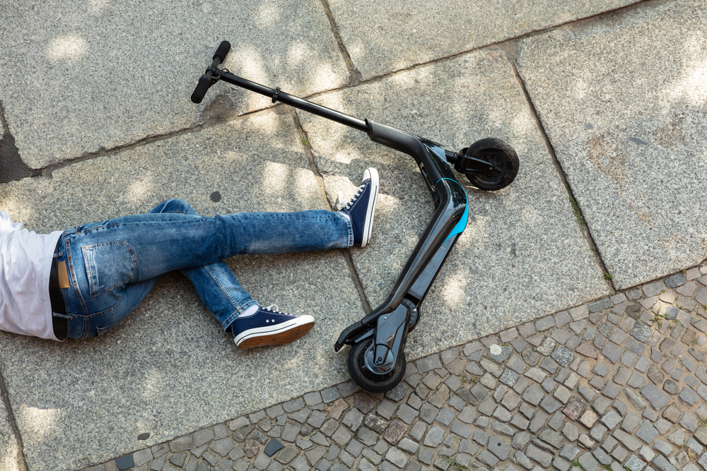 Who is At Fault in a Pedestrian Accident? Unconscious Man Lying On Street After Accident Electric Scooter